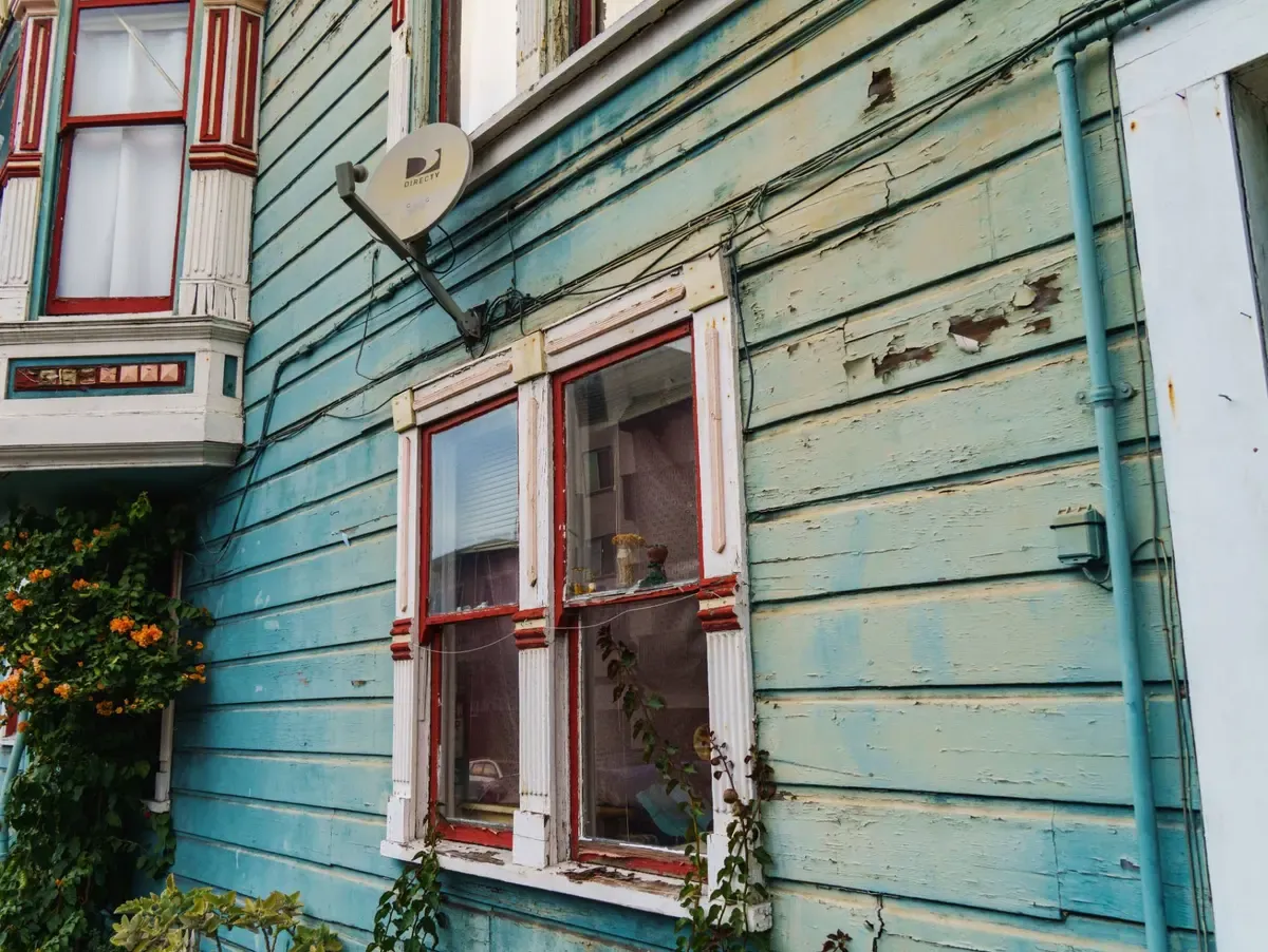 Older home with peeling paint near the windows in Syracuse, New York